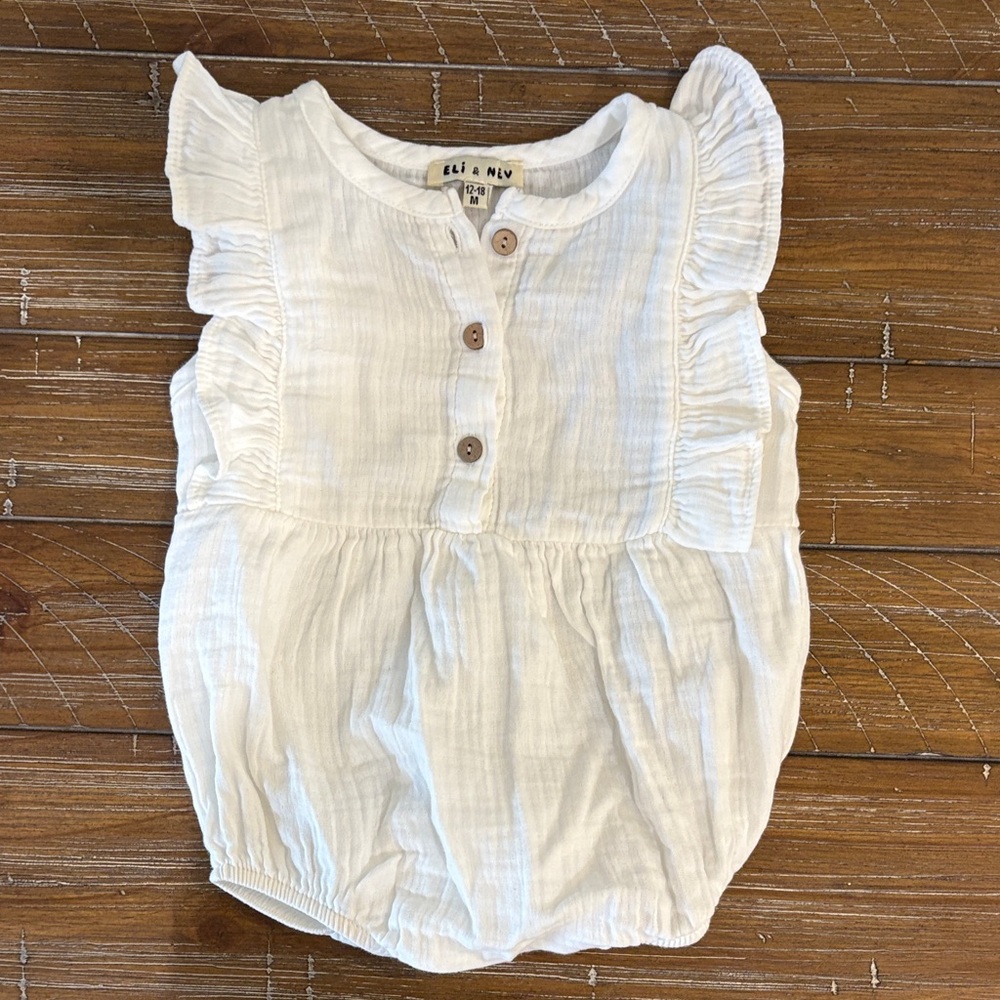 Boutique brand Eli and Nev White Ruffled Baby Romper